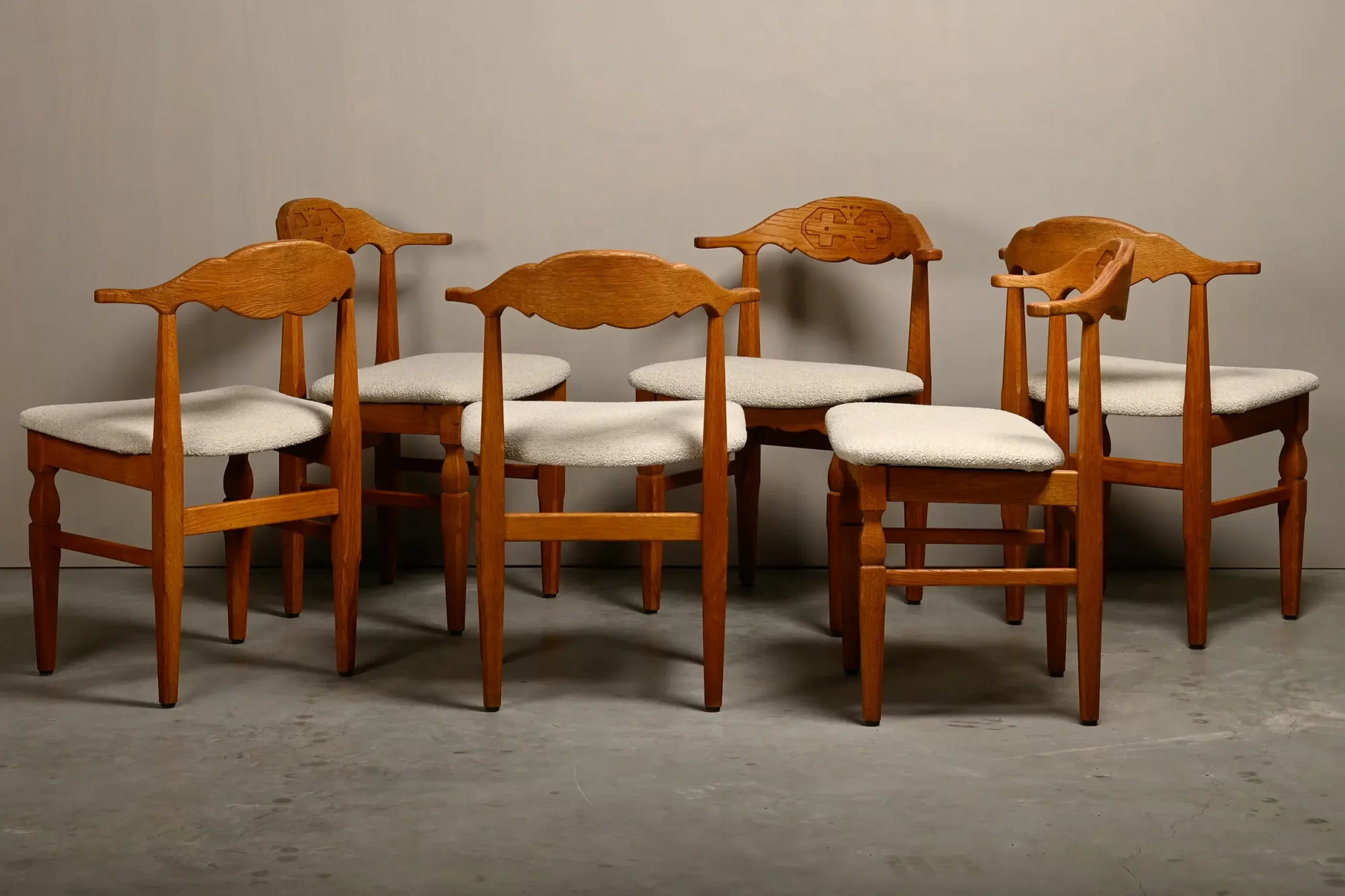 Henning Kjærnulf dining chairs set in Oak and Off White Bouclé, Denmark, 1960s
