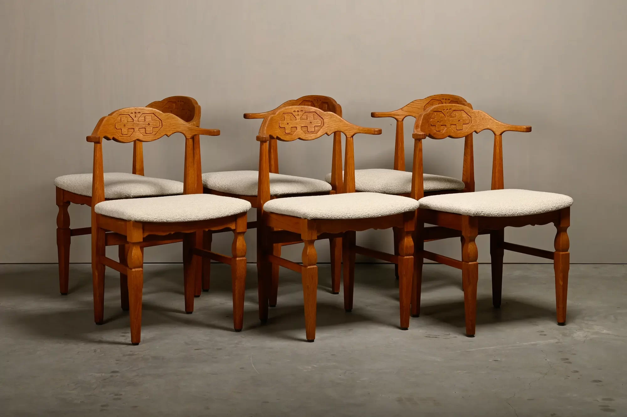 Henning Kjærnulf dining chairs set in Oak and Off White Bouclé, Denmark, 1960s