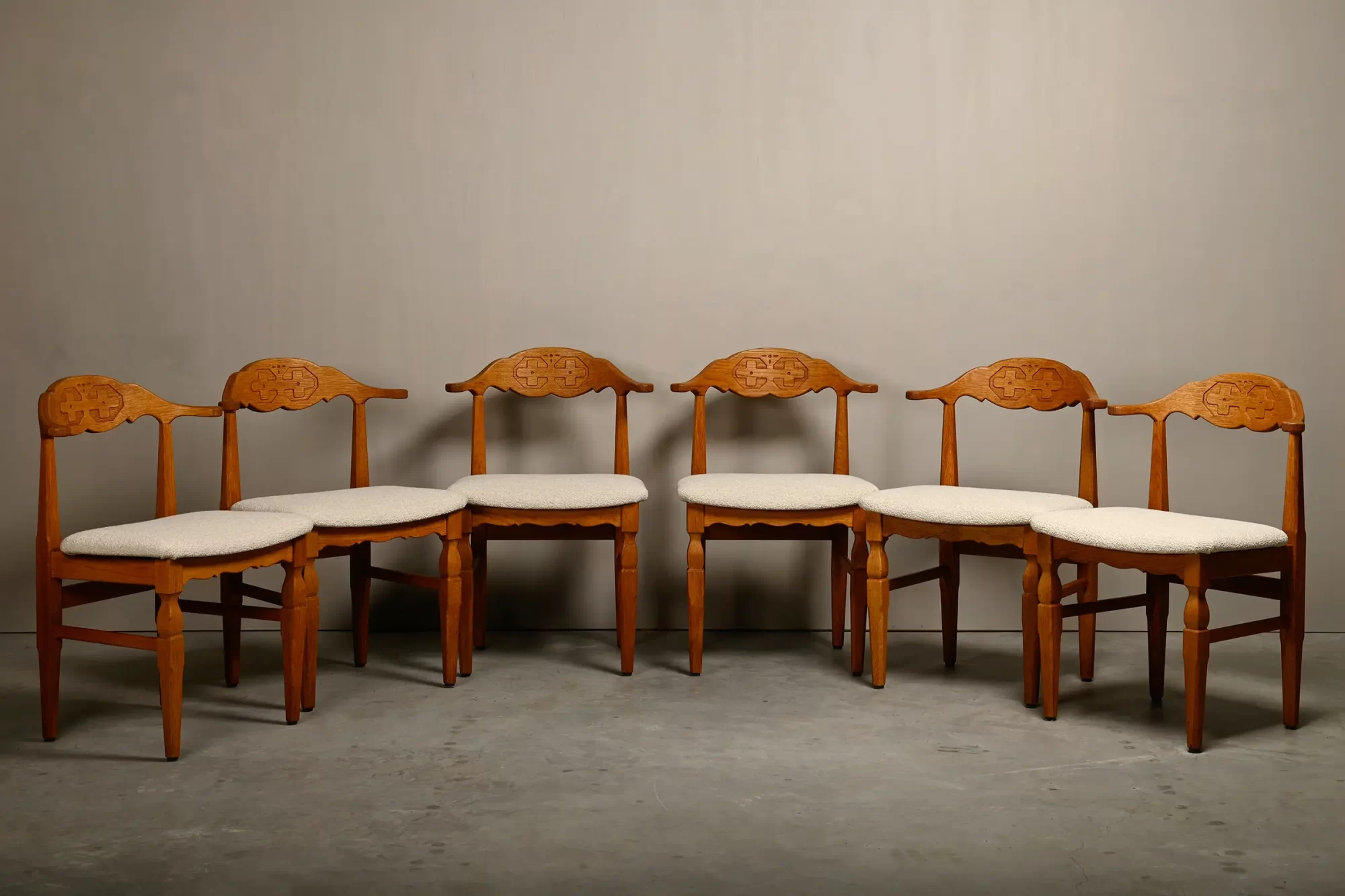 Henning Kjærnulf dining chairs set in Oak and Off White Bouclé, Denmark, 1960s