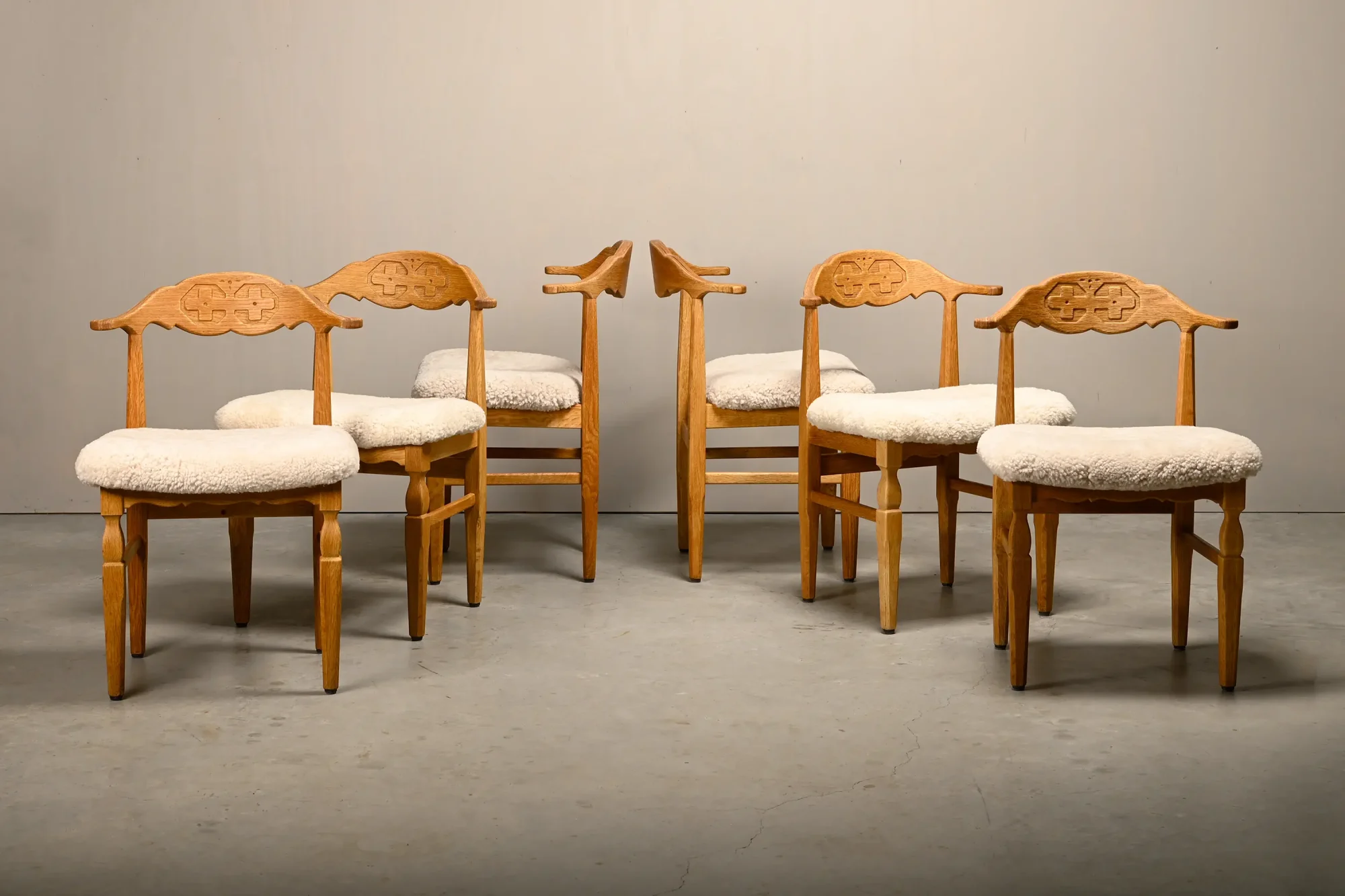 Henning Kjærnulf dining chairs set in Oak and Sheepskin, Denmark, 1960s